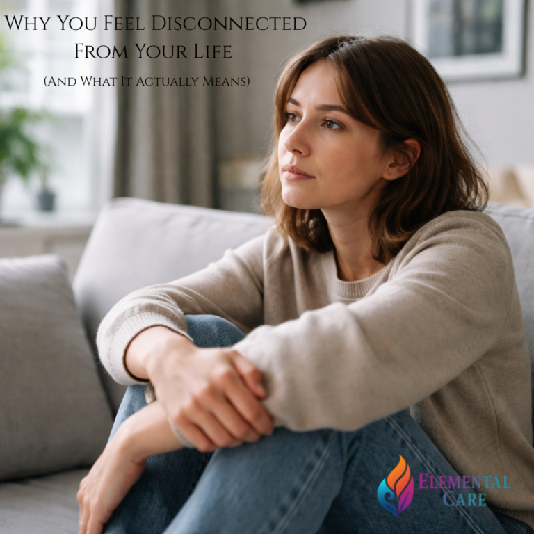 Woman sitting on a couch looking out a window with a distant, reflective expression, representing feeling disconnected from life or emotional numbness